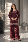 Burgundy two-piece women's suit with white floral embroidery and decorative hem